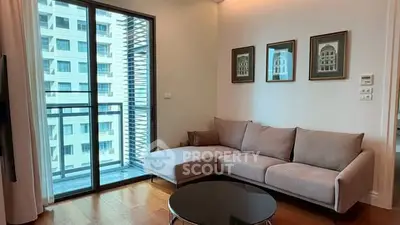 Modern living room with cozy sofa and balcony view in urban apartment.