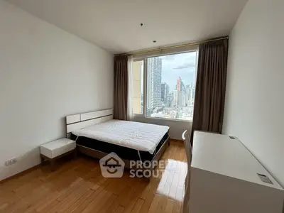 Spacious bedroom with city view in modern apartment