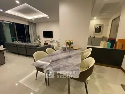 Luxurious open-plan living and dining area with modern furnishings and ambient lighting.