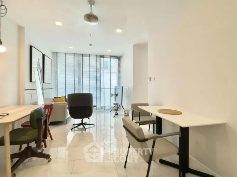 Spacious modern living room with sleek furniture and large windows for natural light.