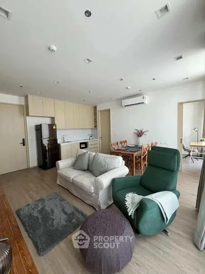 Spacious modern living room with open kitchen and stylish furniture in a contemporary apartment.