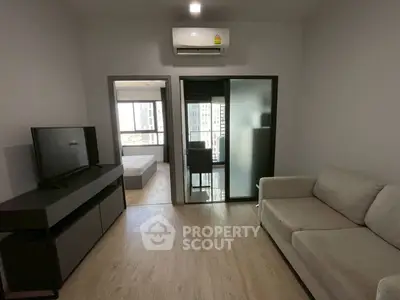 Modern living room with sleek furniture and city view, perfect for urban living.