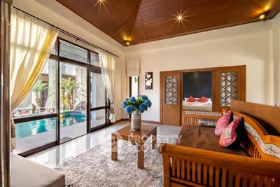 Luxurious living room with pool view and elegant wooden furniture
