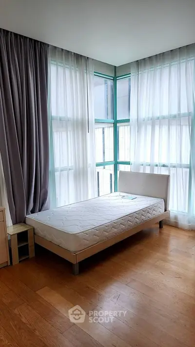 Bright bedroom with large windows and minimalist decor