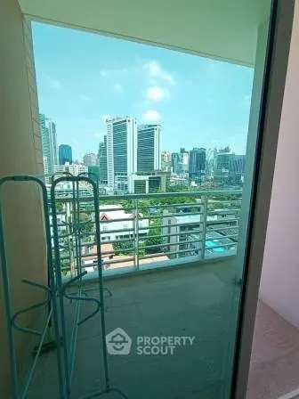 Spacious balcony with stunning city skyline view, perfect for relaxation and enjoying urban living.