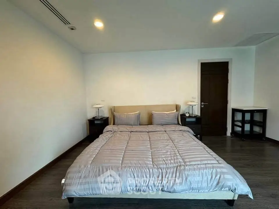 Spacious bedroom with modern decor and cozy ambiance