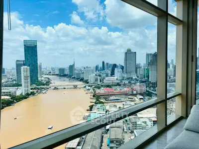 Stunning cityscape view from high-rise apartment window overlooking river and skyline.