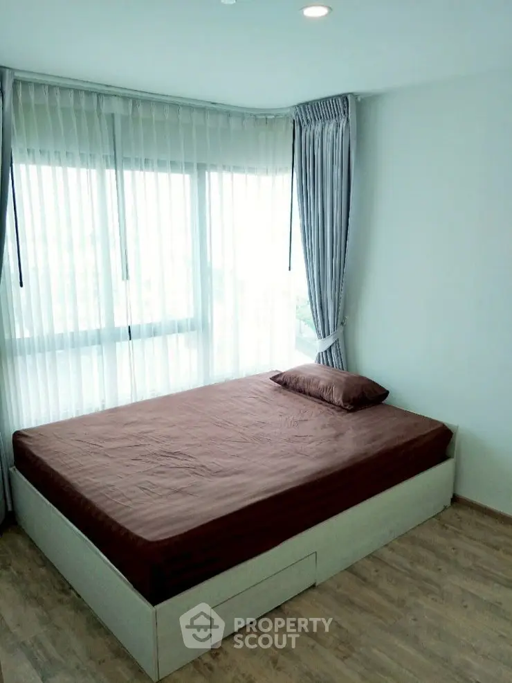 Bright bedroom with large windows and modern decor