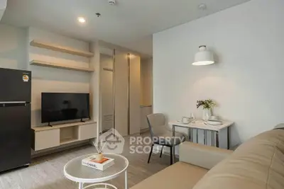 Modern living room with sleek furniture and open layout, featuring a cozy dining area and stylish decor.
