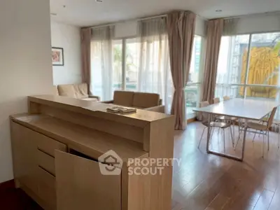 Spacious living room with modern furniture and large windows offering natural light.