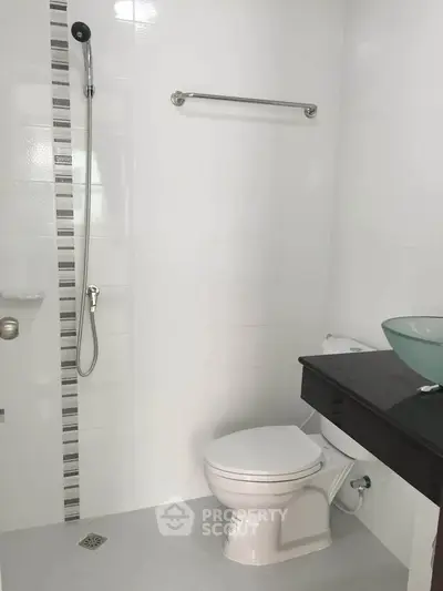 Modern minimalist bathroom with sleek fixtures and glass basin