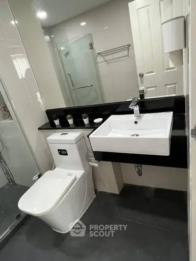 Modern bathroom with sleek fixtures and glass shower enclosure