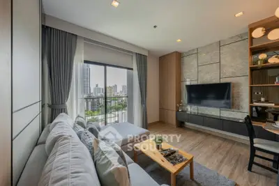 Modern living room with city view, stylish decor, and cozy seating area.