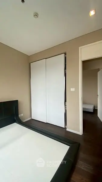 Modern bedroom with sleek design and sliding closet doors