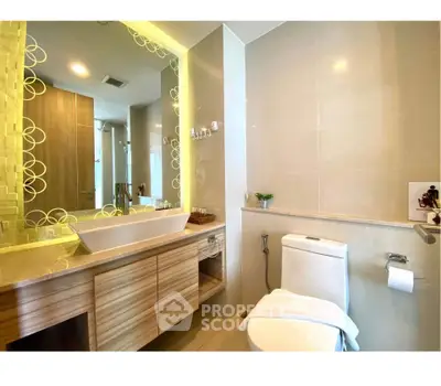 Modern bathroom with elegant vanity and large mirror in a stylish apartment.