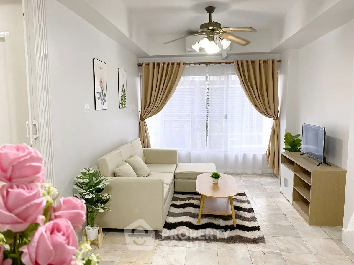 Charming living room with cozy sofa, elegant decor, and natural light, perfect for relaxation.