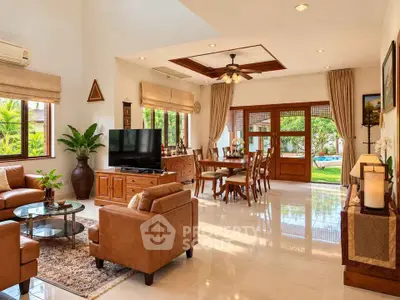 Spacious living room with elegant decor and garden view, perfect for family gatherings.