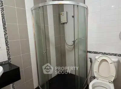 Modern bathroom with glass shower enclosure and sleek tile design