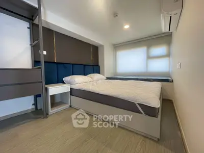 Modern bedroom with stylish decor and ample natural light