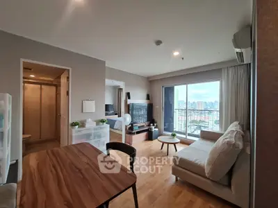 Modern apartment with open living area and balcony offering stunning city views.