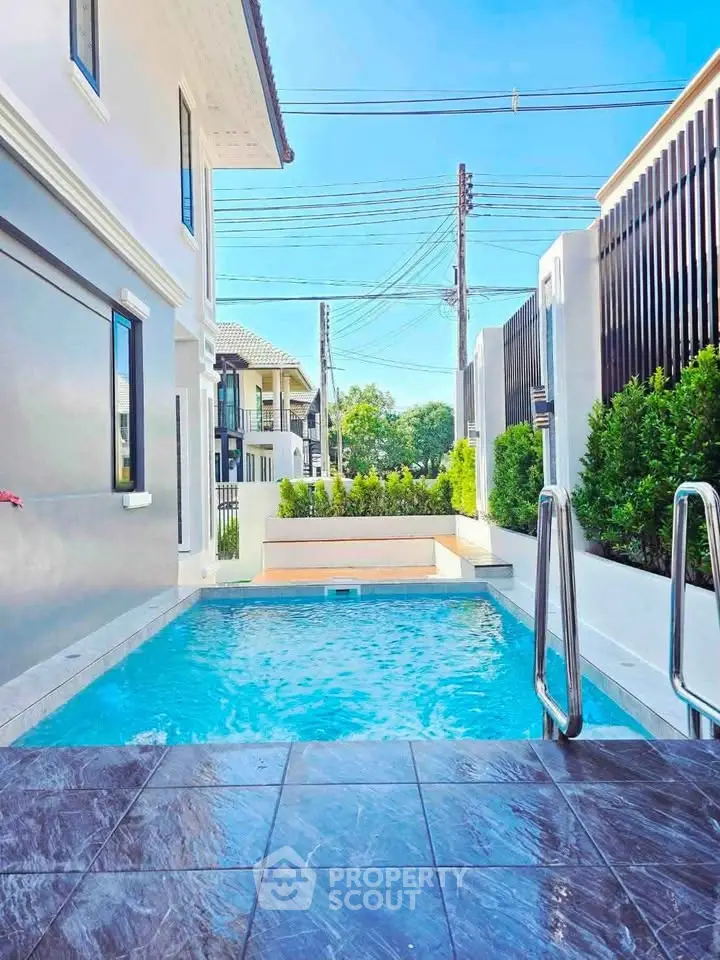 Luxurious private pool area with modern design and lush greenery, perfect for relaxation and entertainment.