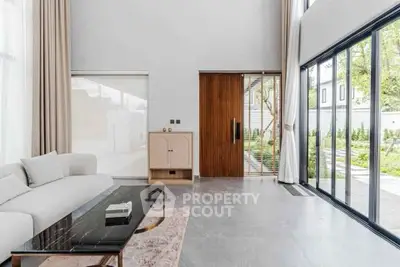 Spacious modern living room with floor-to-ceiling windows and elegant decor