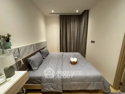 Modern bedroom with stylish decor and cozy ambiance, featuring a comfortable bed and elegant curtains.
