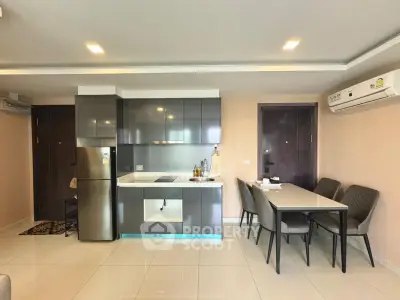 Modern kitchen and dining area with sleek cabinetry and air conditioning in a stylish apartment.
