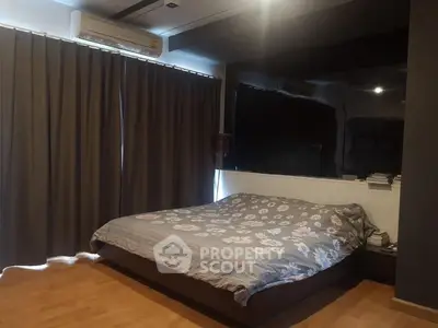 Cozy bedroom with modern design and floral bedding in a stylish apartment.