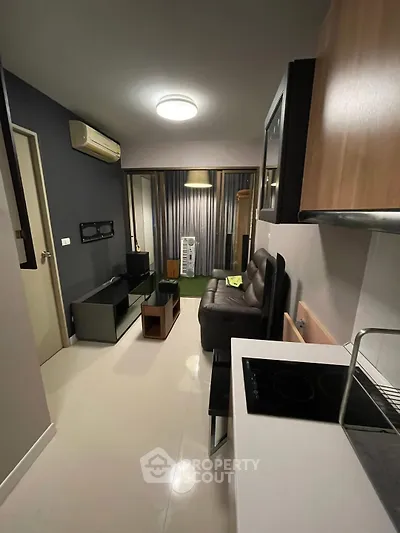 Modern living room with sleek furniture and open kitchen layout