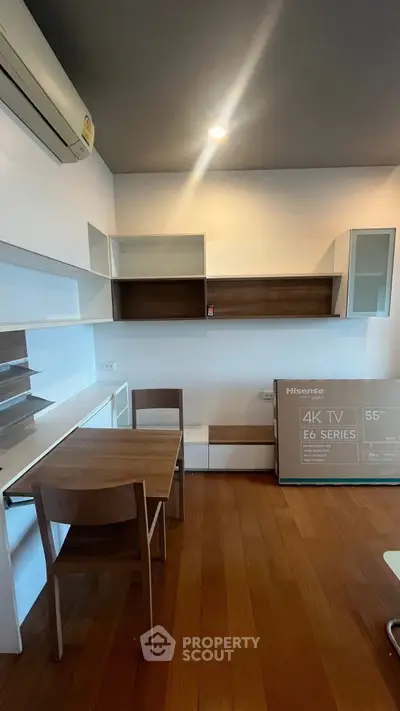 Modern living room with sleek furniture and a 55-inch 4K TV, perfect for entertainment.