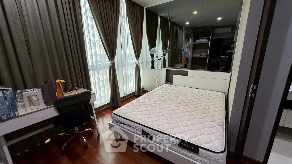 Modern bedroom with large windows and stylish decor
