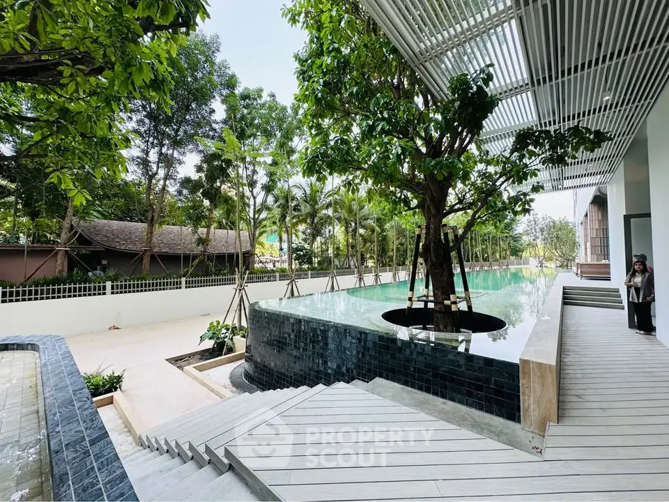 Luxurious outdoor pool area with modern design and lush greenery
