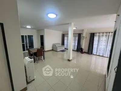 Spacious living room with modern furniture and large windows for natural light.