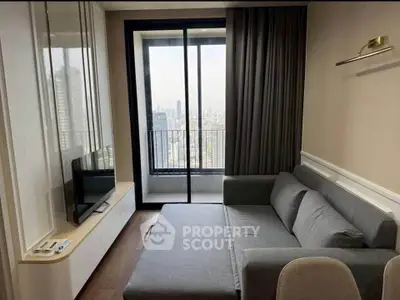 Modern living room with city view balcony and sleek gray sofa