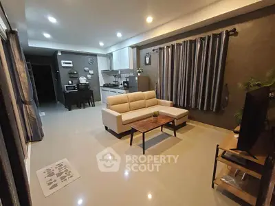 Modern open-plan living room with sleek kitchen and cozy seating area