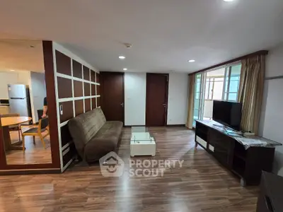 Spacious living room with modern decor and wooden flooring