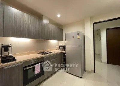 Modern kitchen with sleek cabinetry and stainless steel appliances in a stylish apartment.