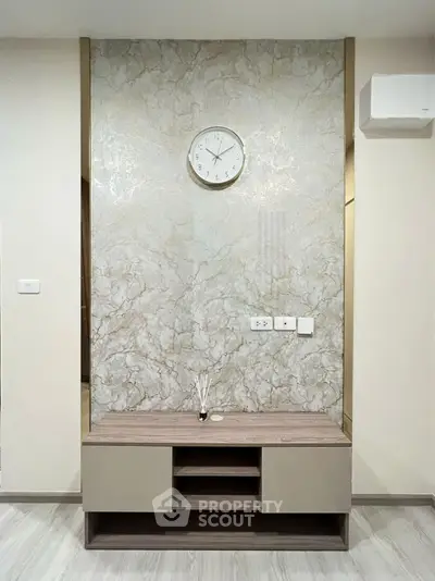 Modern living room with elegant marble accent wall and stylish wooden console