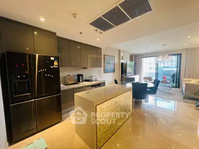Luxurious open-layout kitchen and living room with modern appliances and elegant decor.