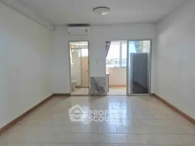 Spacious unfurnished room with tiled flooring and natural light, ideal for customization.