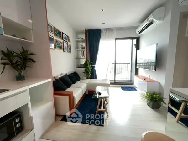 Modern living room with balcony, sleek furniture, and natural light