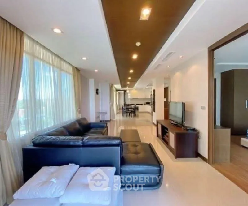 Spacious modern living room with elegant decor and large windows