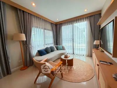 Stylish living room with modern decor and large windows offering natural light.