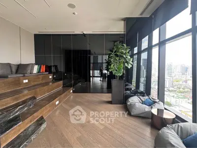 Modern high-rise building interior with panoramic city view and stylish seating area.