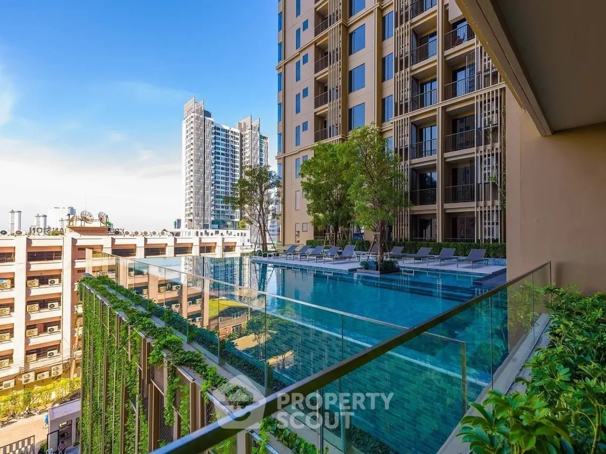 Luxurious high-rise building with stunning rooftop pool and city view, perfect for urban living.