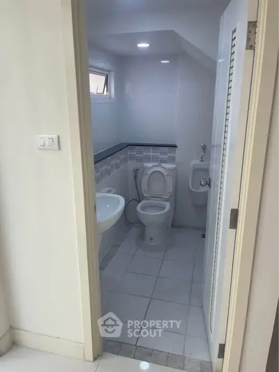Compact bathroom with modern fixtures and natural light