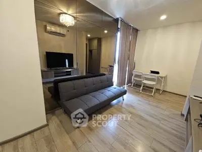 Modern living room with sleek sofa and mirrored wall, perfect for urban living.