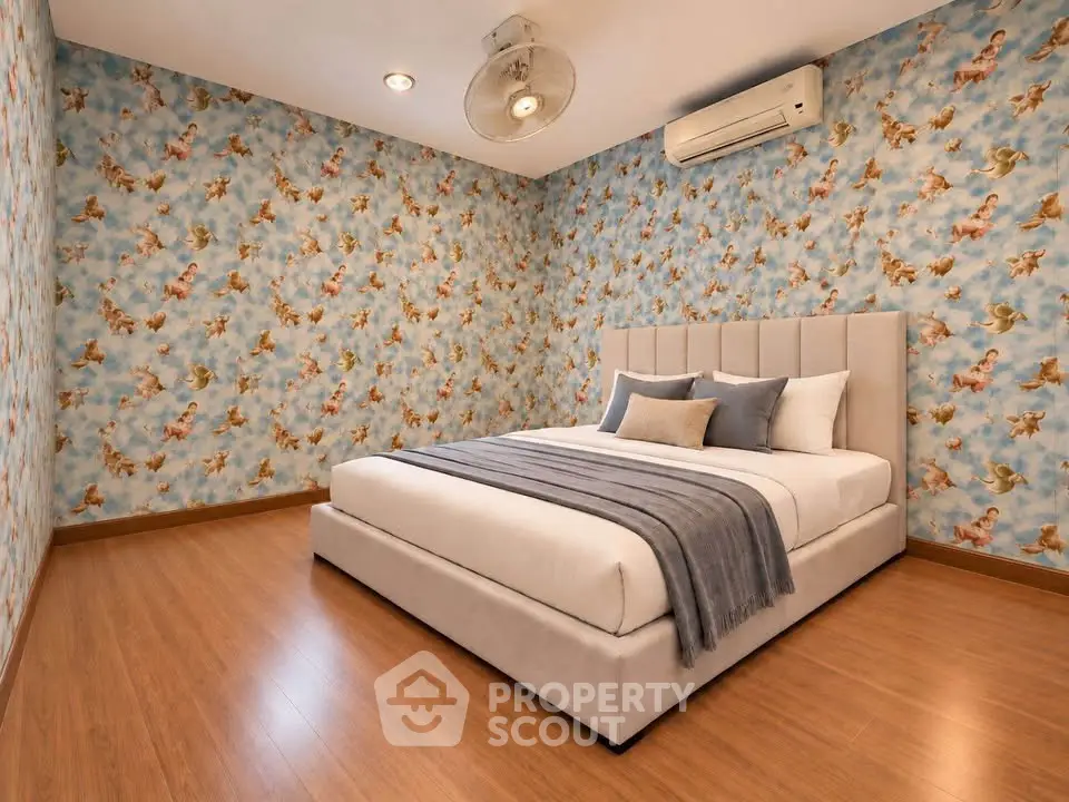 Elegant bedroom with stylish wallpaper and modern furnishings, featuring a cozy bed and air conditioning.