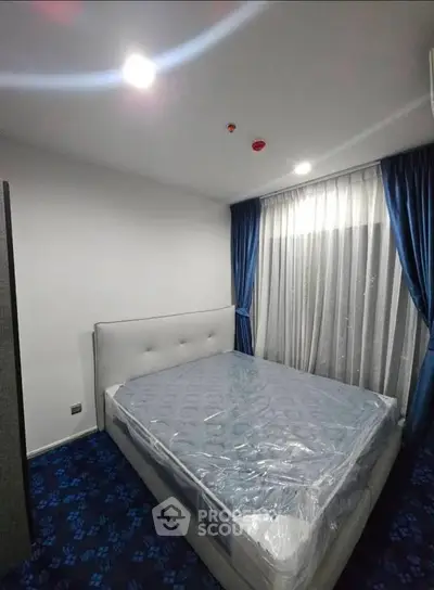 Modern bedroom with plush carpet and elegant curtains in a stylish apartment.